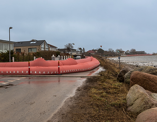 Pink water tube on the shore in Frederikssund to prevent flooding from Storm Malik
